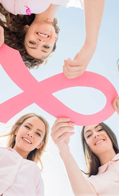 Hands joined in circle holding breast cancer struggle symbol 