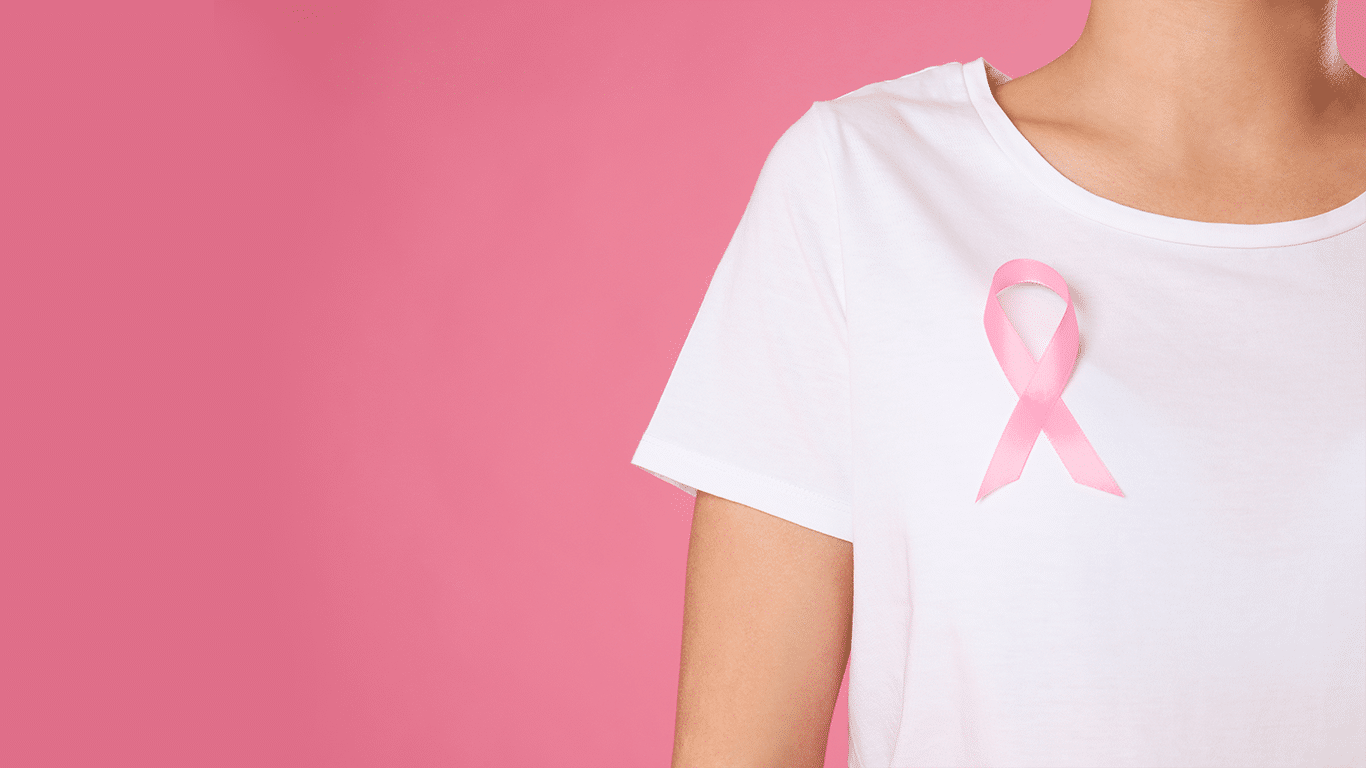 Lovely pleasant looking woman with happy expression, picks up curly hair in pony tail, has fun, glad to buy new striped sweater, being in good mood, poses at white studio  Beauty, youth concept